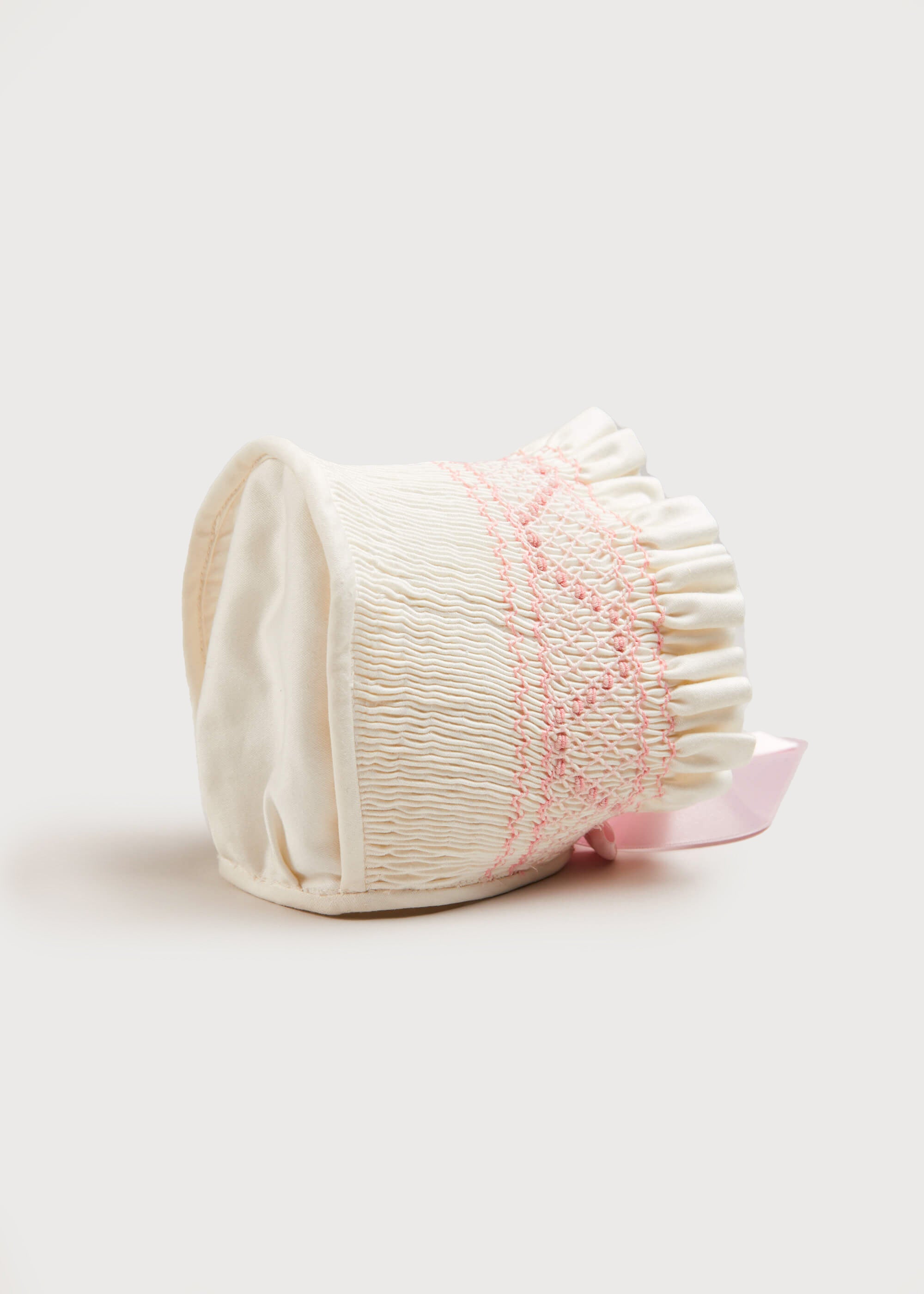 Off White and Pink Hand Smocked Baby Bonnet Knitted Accessories  from Pepa London