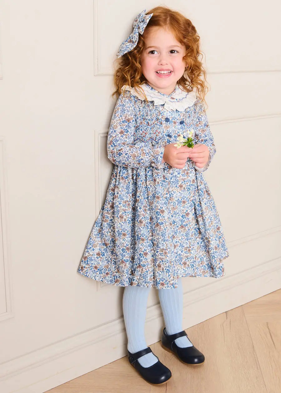 Beatrice Floral Hand Smocked Double Breasted Long Sleeve Dress in Blue (18mths-10yrs) Beatrice Floral Hand Smocked Double Breasted Long Sleeve Dress in Blue (18mths-10yrs)