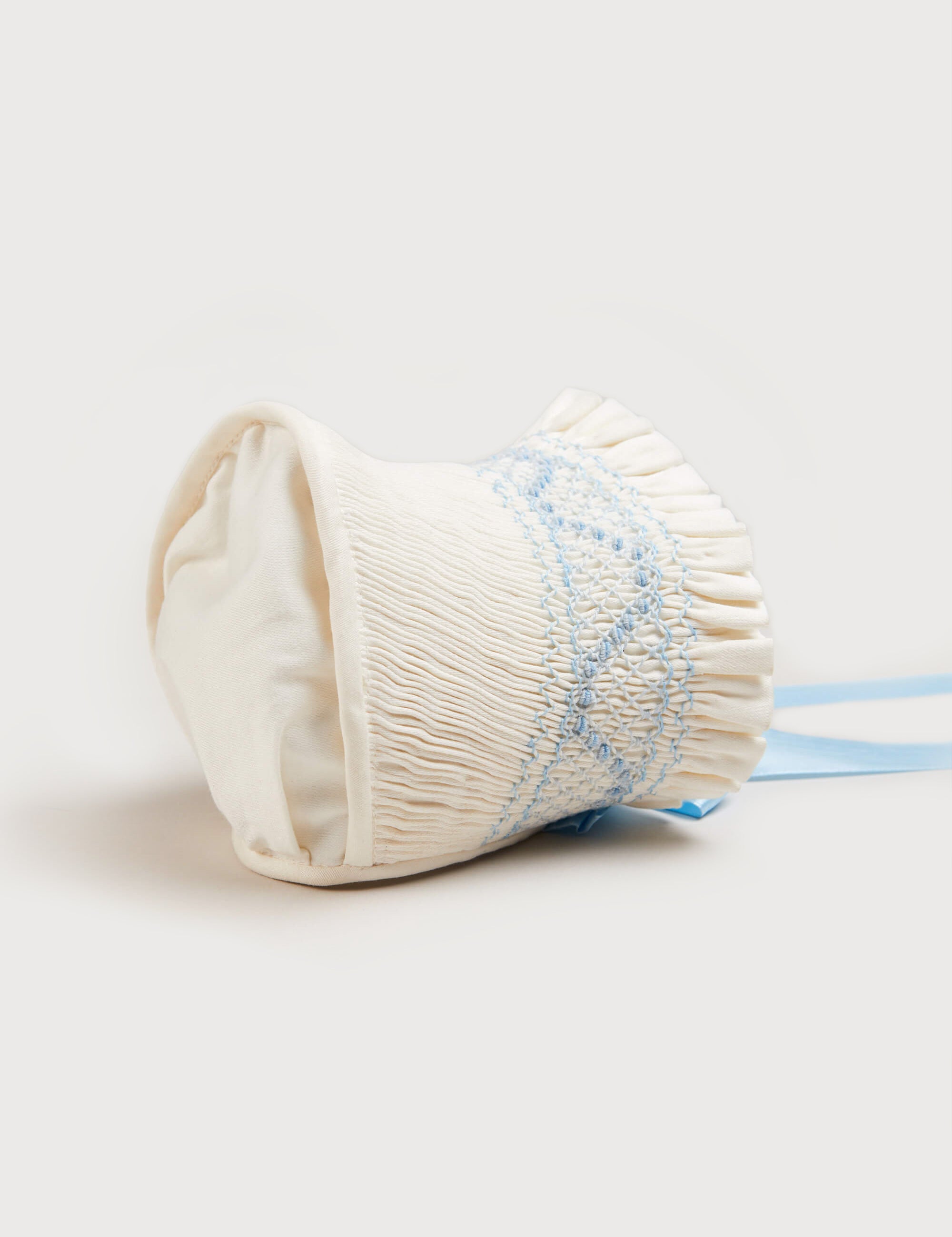Off White and Blue Hand Smocked Baby Bonnet Knitted Accessories  from Pepa London