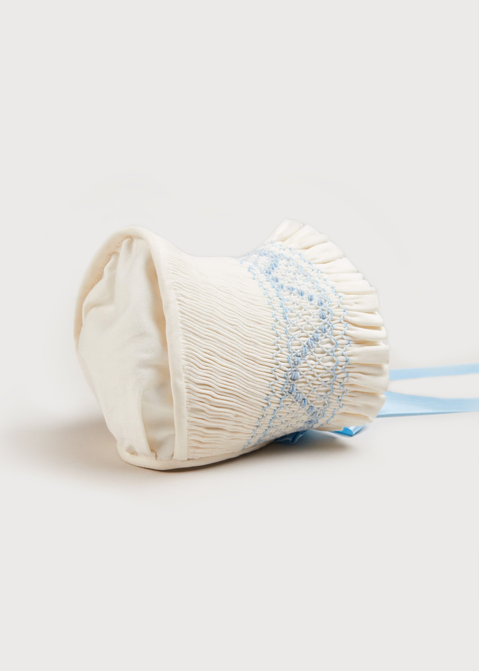 Off White and Blue Hand Smocked Baby Bonnet Knitted Accessories  from Pepa London