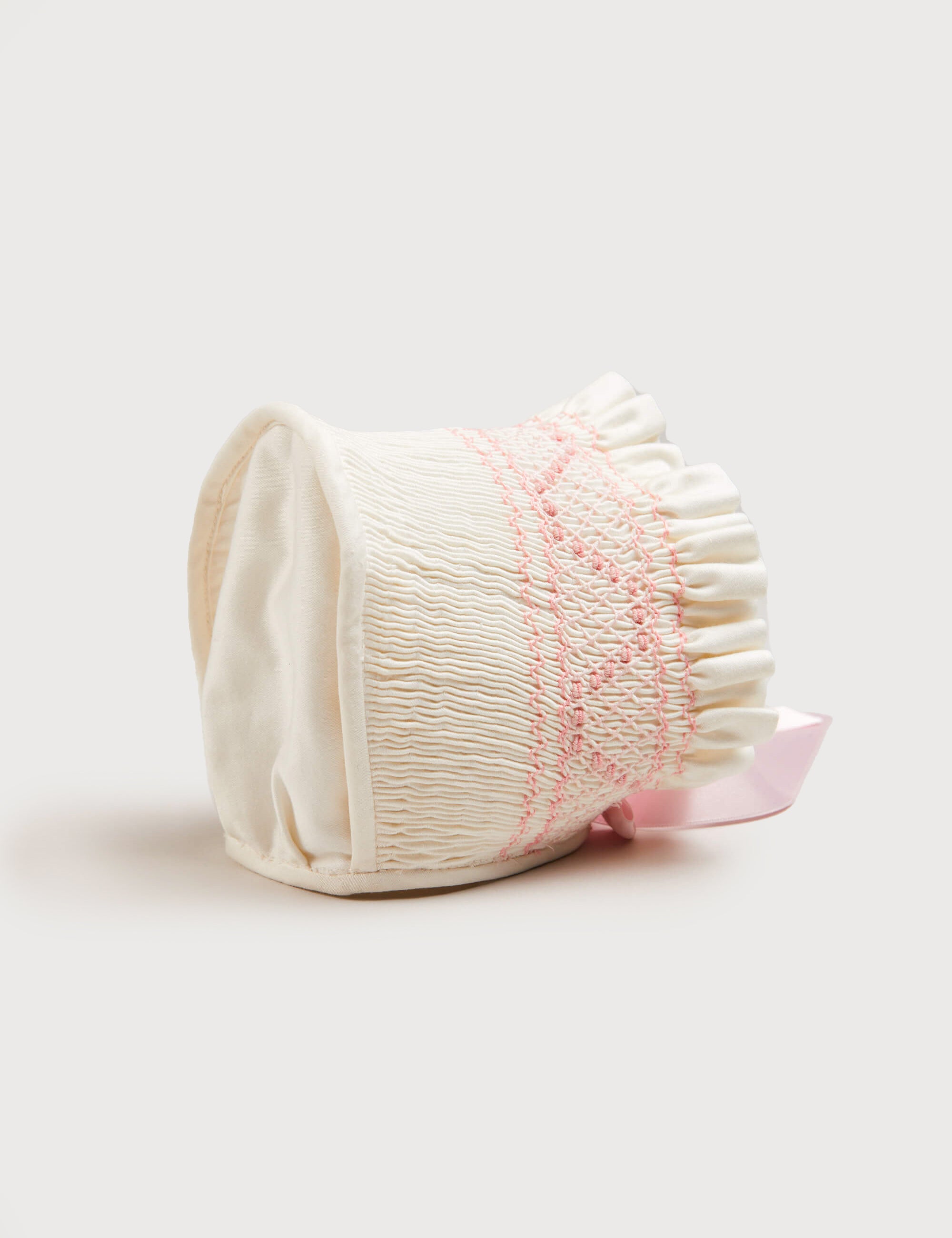 Off White and Pink Hand Smocked Baby Bonnet Knitted Accessories  from Pepa London