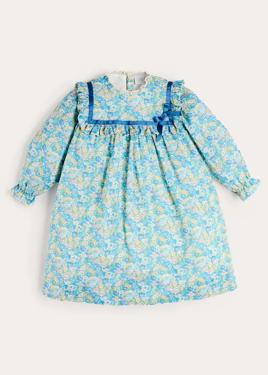 Leontyne Floral Bow Detail Long Sleeve Trapeze Dress in Blue Made with Liberty Fabric (18mths- 10yrs) Leontyne Floral Bow Detail Long Sleeve Trapeze Dress in Blue Made with Liberty Fabric (18mths- 10yrs)