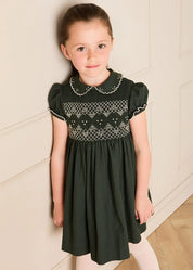 The Icon Hand Smocked Peter Pan Collar Short Sleeve Dress in Racing Green (18mths-10yrs) Dresses from Pepa London