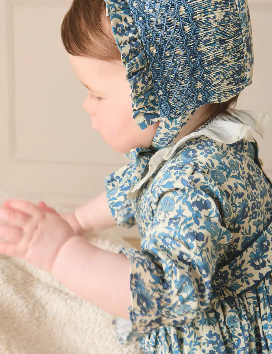 Daphne Floral Hand Smocked Bonnet in Blue (S-L) Knitted Accessories from Pepa London