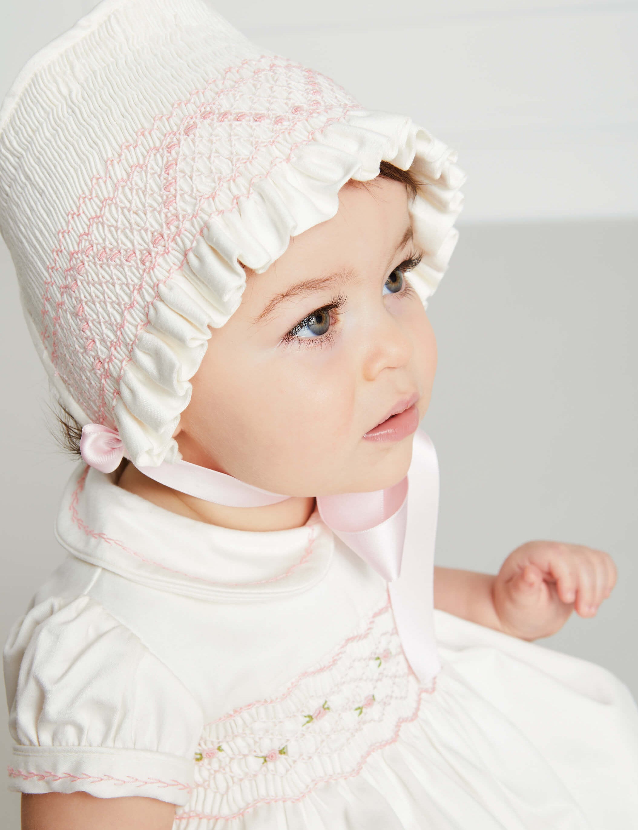 Off White and Pink Hand Smocked Baby Bonnet Knitted Accessories  from Pepa London