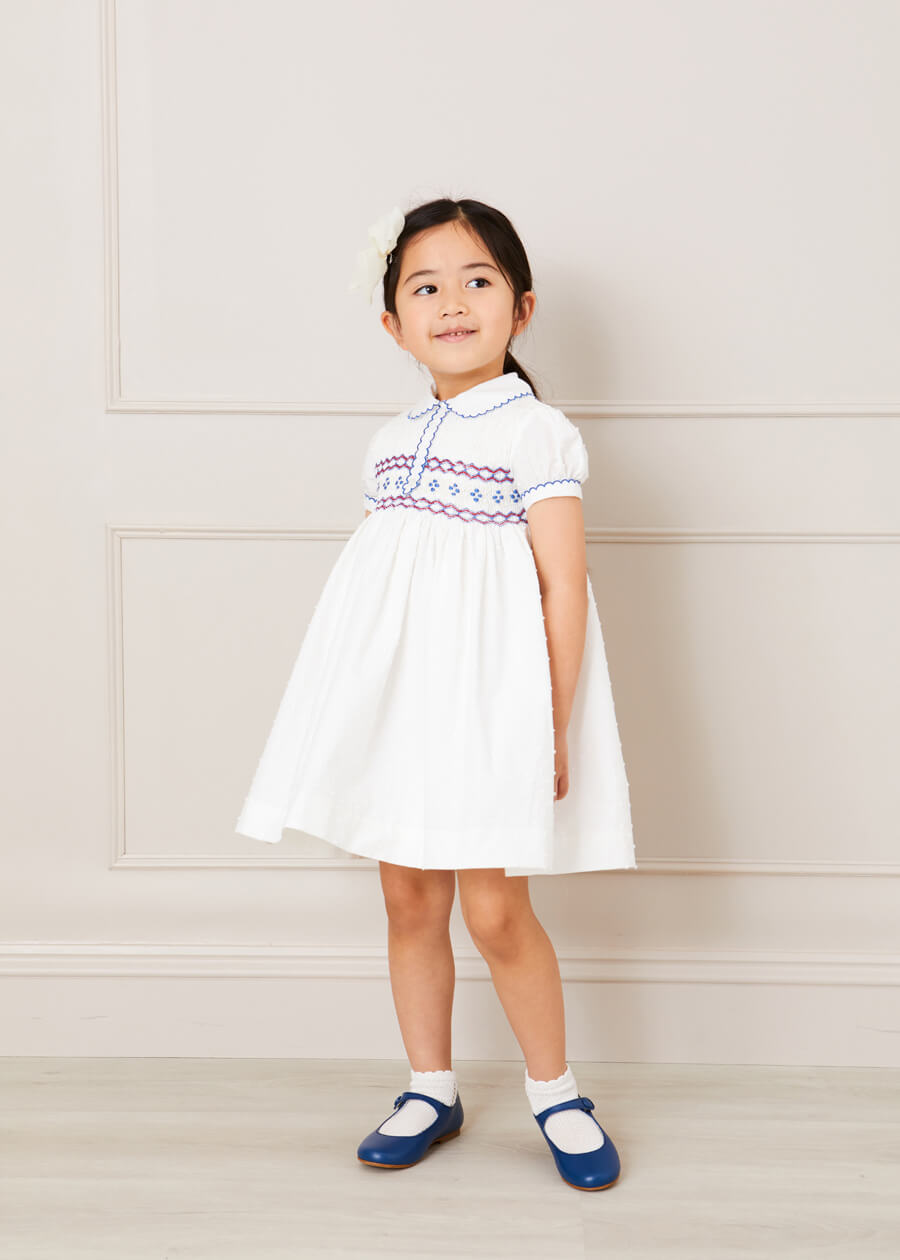 Hand Smocked Plumetti Short Sleeve Dress in White (12mths-6yrs) Dresses  from Pepa London