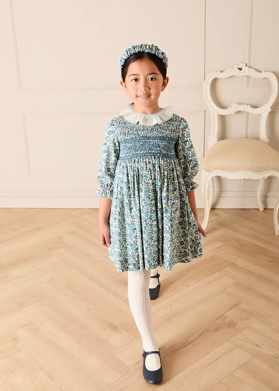 Daphne Floral Hand Smocked Frill Collar Long Sleeve Dress in Blue (18mths-10yrs) Dresses from Pepa London