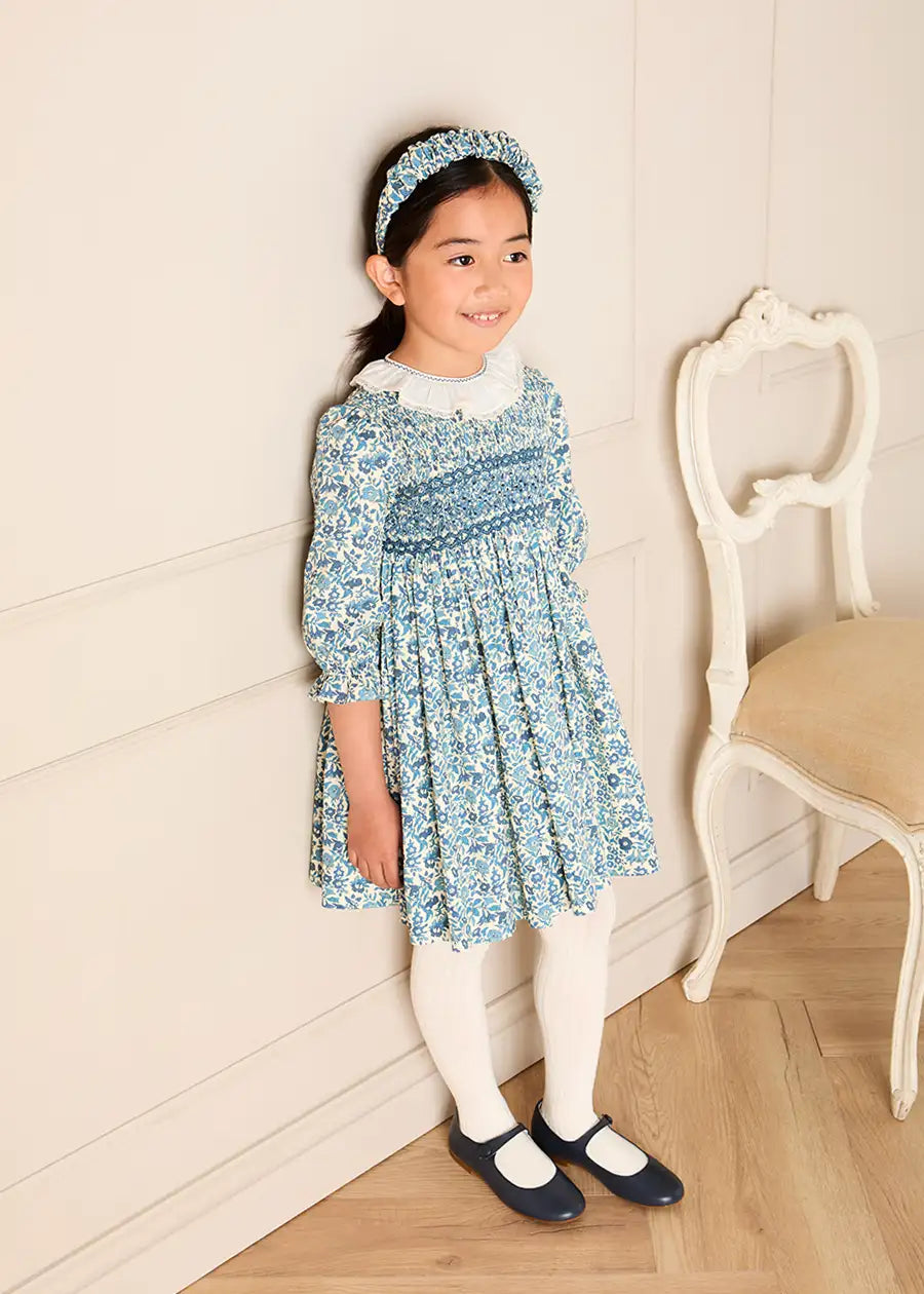 Daphne Floral Hand Smocked Frill Collar Long Sleeve Dress in Blue (18mths-10yrs) Dresses from Pepa London
