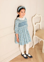 Daphne Floral Hand Smocked Frill Collar Long Sleeve Dress in Blue (18mths-10yrs) Dresses from Pepa London