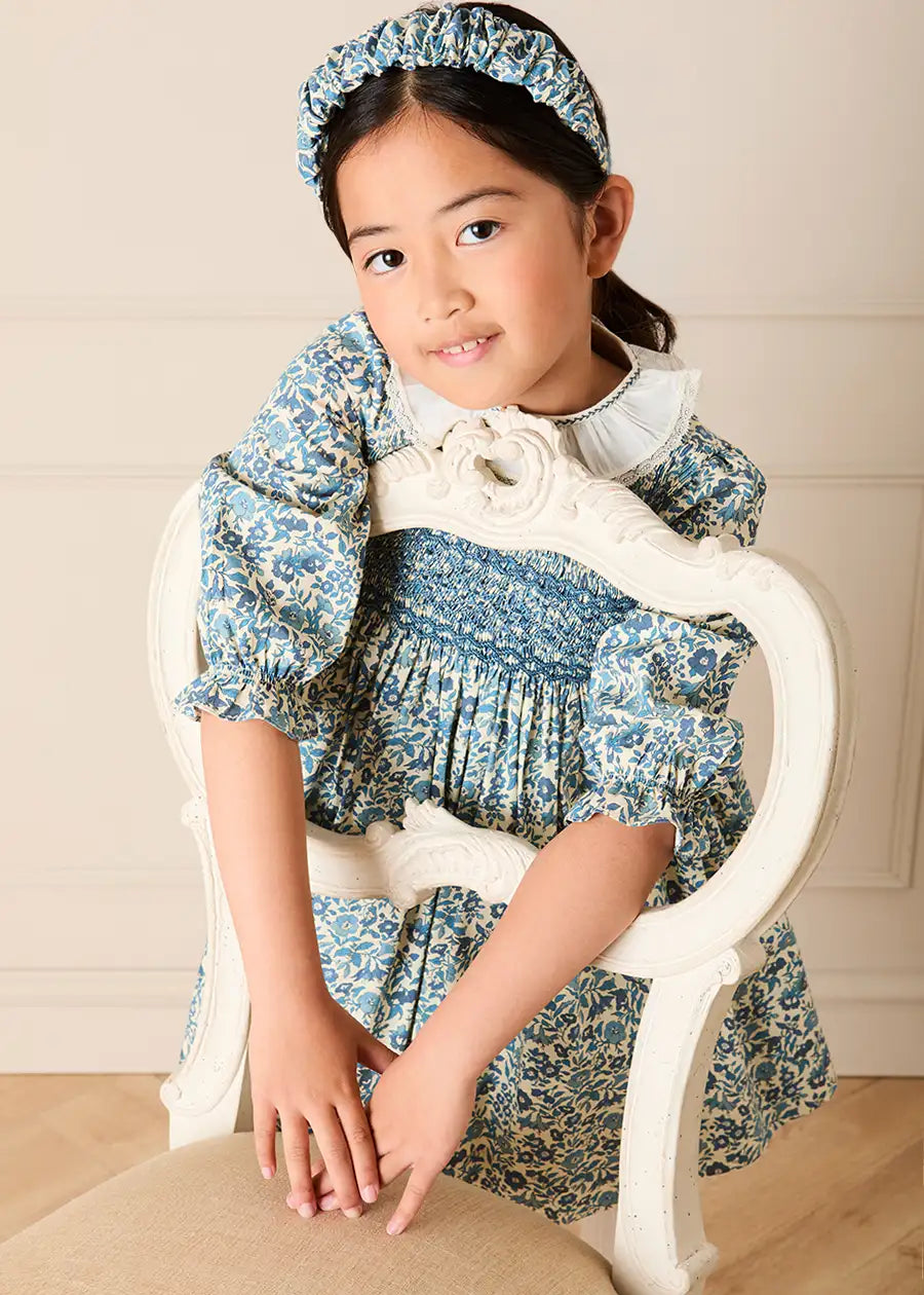 Daphne Floral Hand Smocked Frill Collar Long Sleeve Dress in Blue (18mths-10yrs) Dresses from Pepa London