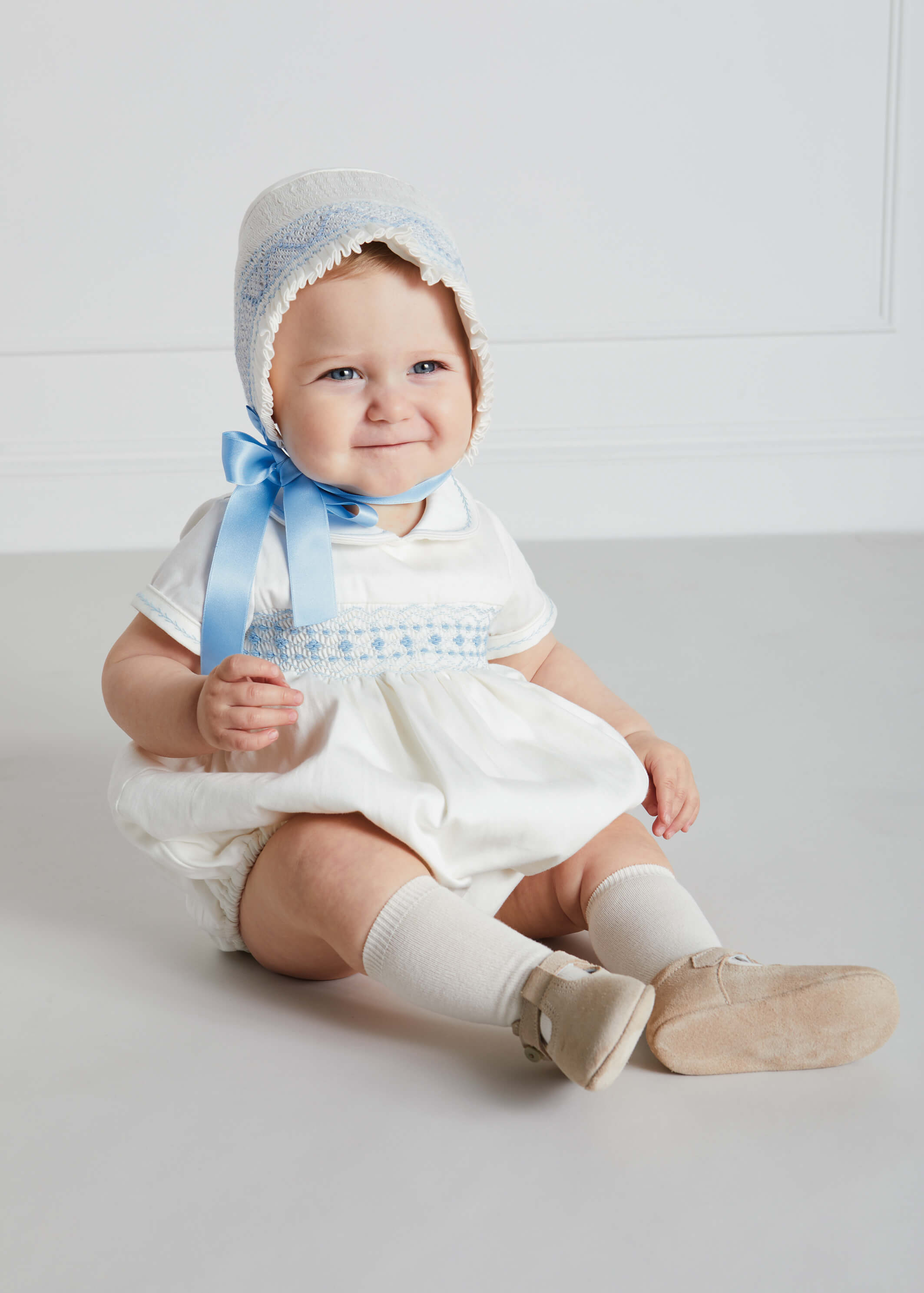 Classic Off-White Blue Hand Smocked Romper (3-18mths) Rompers  from Pepa London