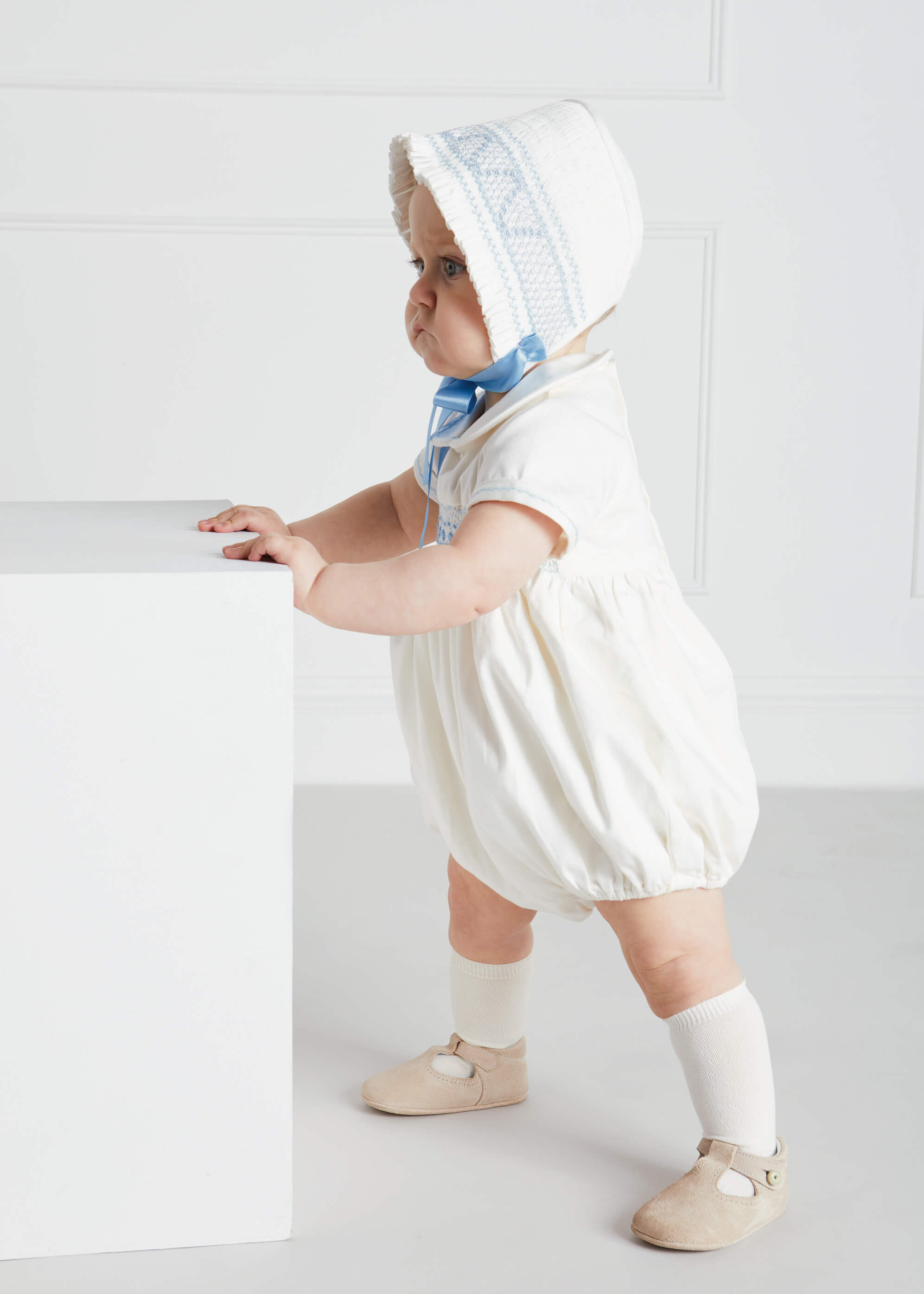 Off White and Blue Hand Smocked Baby Bonnet Knitted Accessories  from Pepa London