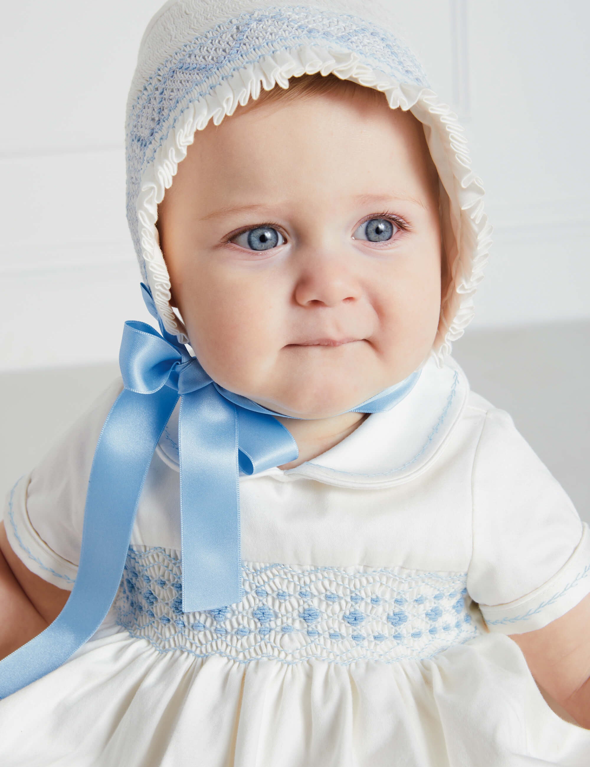 Off White and Blue Hand Smocked Baby Bonnet Knitted Accessories  from Pepa London